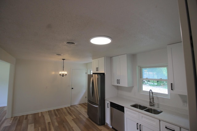 151 Dawn St, Morrison, TN 37357 - kitchen featuring stainless steel appliances, a textured ceiling, light countertops, white cabinetry, and light wood-style floors