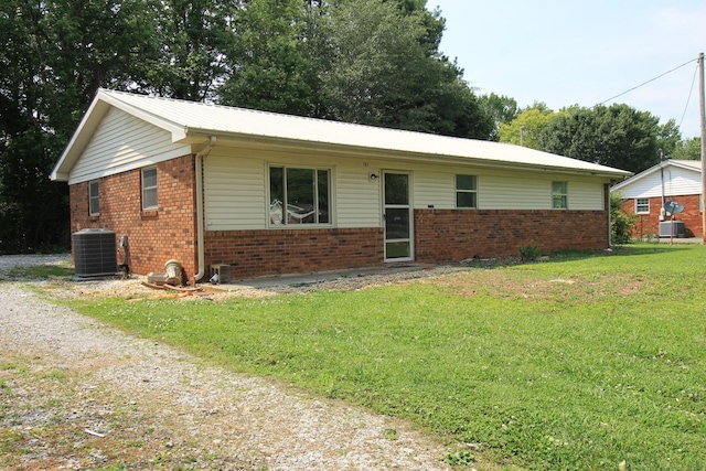 151 Dawn St, Morrison, TN 37357 - ranch-style home with brick siding, a front lawn, and a metal roof