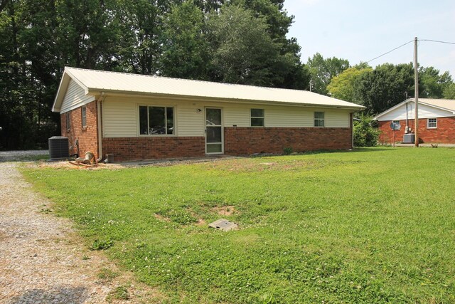 151 Dawn St, Morrison, TN 37357 - single story home featuring a front yard, brick siding, driveway, and a metal roof