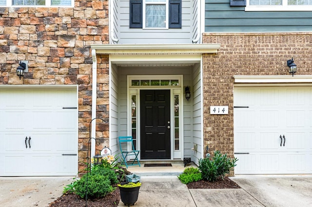 414 Manor Row, Pleasant View, TN 37146 - view of exterior entry with brick siding, concrete driveway, and a garage