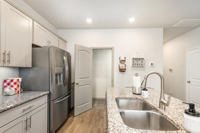 414 Manor Row, Pleasant View, TN 37146 - kitchen featuring stainless steel fridge with ice dispenser, light wood-style flooring, backsplash, recessed lighting, and light stone counters