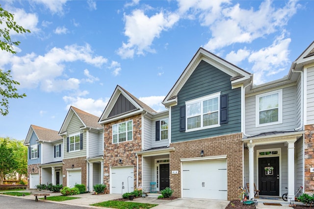 414 Manor Row, Pleasant View, TN 37146 - townhome / multi-family property featuring stone siding, concrete driveway, a garage, and brick siding