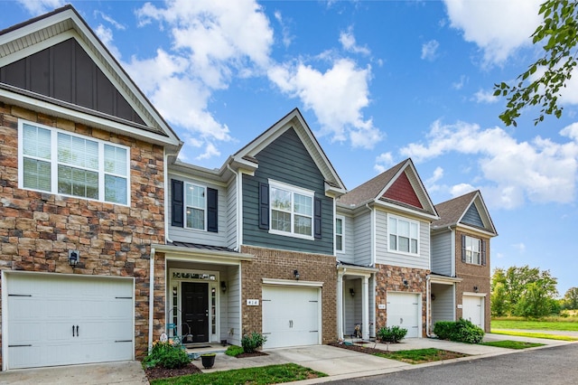 414 Manor Row, Pleasant View, TN 37146 - townhome / multi-family property with a garage, stone siding, and driveway