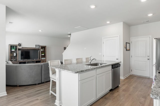 2400 Kaycee Ct, Lebanon, TN 37087 - kitchen with stainless steel dishwasher, light wood-type flooring, light stone countertops, a center island with sink, and recessed lighting