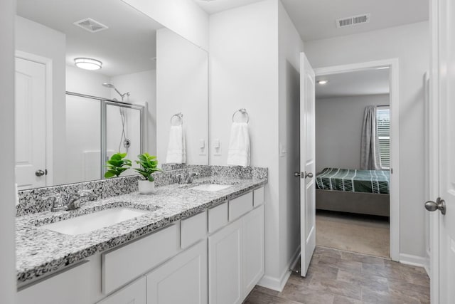 2400 Kaycee Ct, Lebanon, TN 37087 - bathroom featuring connected bathroom, double vanity, a shower with shower door, and stone finish floors