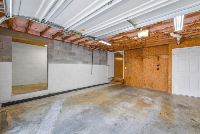 1128 Tiftonia View Rd, Chattanooga, TN 37419 - garage featuring a garage door opener and concrete block wall