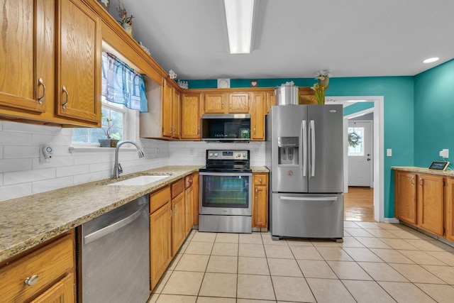 1128 Tiftonia View Rd, Chattanooga, TN 37419 - kitchen featuring stainless steel appliances, brown cabinetry, and decorative backsplash