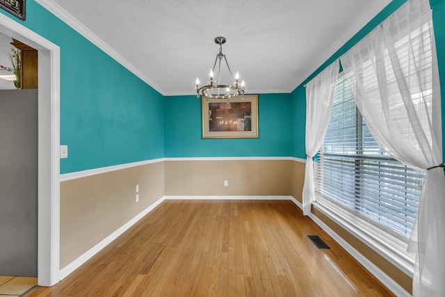 1128 Tiftonia View Rd, Chattanooga, TN 37419 - unfurnished room featuring a chandelier, hardwood / wood-style flooring, crown molding, and a textured ceiling