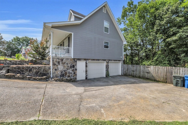1128 Tiftonia View Rd, Chattanooga, TN 37419 - view of side of property with a garage, stone siding, and concrete driveway