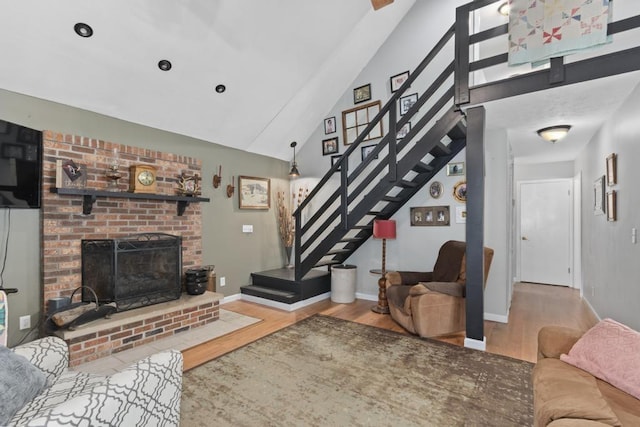 70 Nancy Ave, Cadiz, KY 42211 - living area with wood finished floors, stairs, a fireplace, and vaulted ceiling