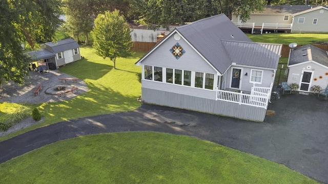 70 Nancy Ave, Cadiz, KY 42211 - view of front of house with an outdoor structure, a front yard, and a metal roof