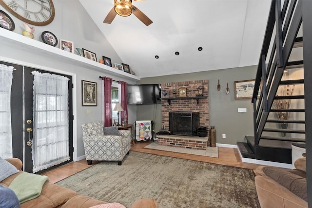 70 Nancy Ave, Cadiz, KY 42211 - living room featuring stairs, ceiling fan, wood finished floors, a brick fireplace, and high vaulted ceiling