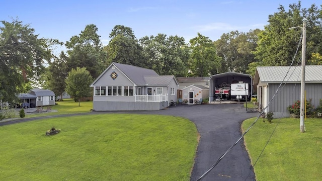 70 Nancy Ave, Cadiz, KY 42211 - view of front of property with a detached carport, a front yard, driveway, and a metal roof