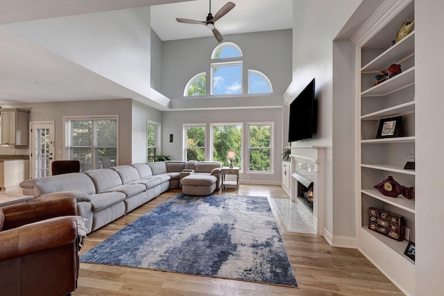 206 Stillcreek Dr, Franklin, TN 37064 - living room featuring a towering ceiling, a high end fireplace, ceiling fan, and light wood-type flooring