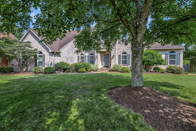 206 Stillcreek Dr, Franklin, TN 37064 - view of property hidden behind natural elements featuring brick siding, a front yard, and a shingled roof