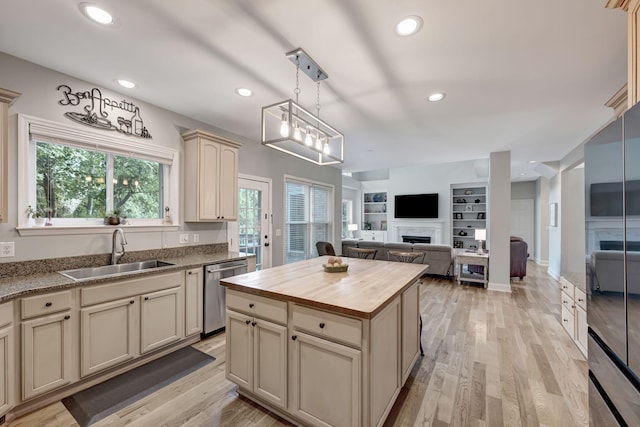 206 Stillcreek Dr, Franklin, TN 37064 - kitchen with dishwasher, cream cabinets, wood counters, a fireplace, and recessed lighting