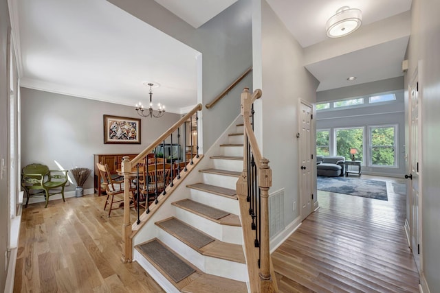 206 Stillcreek Dr, Franklin, TN 37064 - stairs featuring wood finished floors and a chandelier