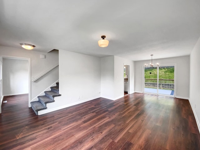 480 Bamburg Dr, Clarksville, TN 37040 - unfurnished living room featuring a chandelier, stairway, and dark wood-type flooring