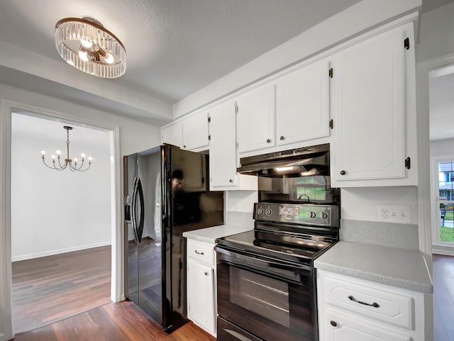 480 Bamburg Dr, Clarksville, TN 37040 - kitchen featuring black appliances, under cabinet range hood, a chandelier, dark wood finished floors, and light countertops