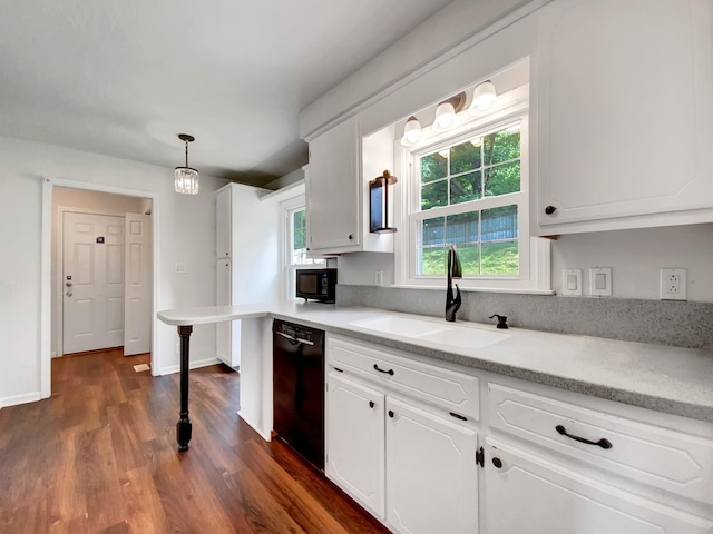 480 Bamburg Dr, Clarksville, TN 37040 - kitchen featuring black appliances, white cabinets, light countertops, dark wood-type flooring, and decorative light fixtures