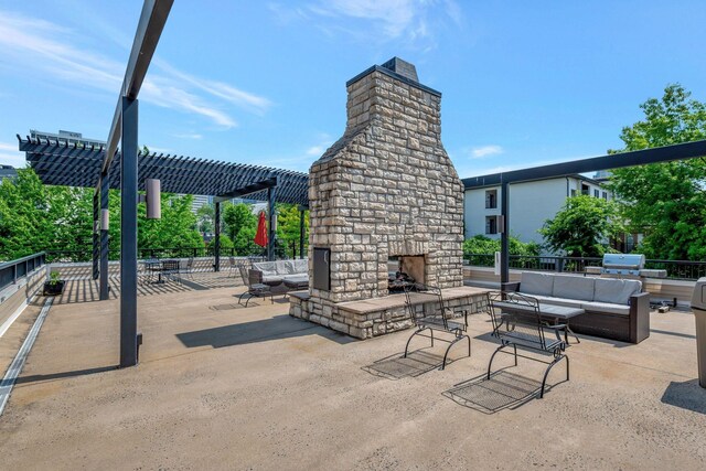 301 Criddle St Unit 304, Nashville, TN 37219 - view of patio / terrace with an outdoor living space with a fireplace and a pergola
