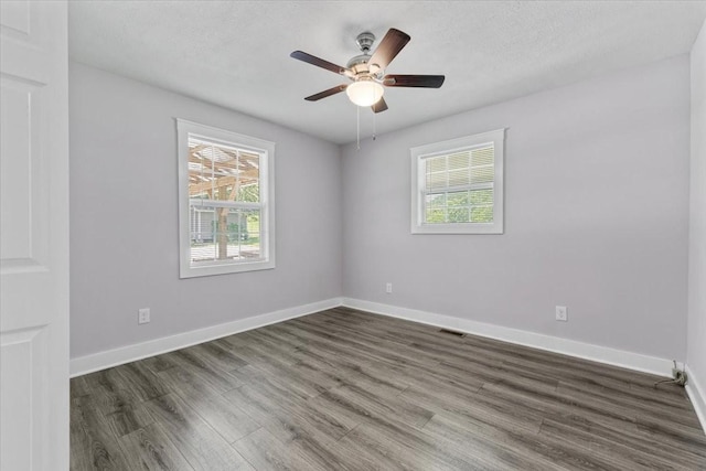 49 Je Sartain Rd, Manchester, TN 37355 - empty room with healthy amount of natural light, dark wood finished floors, and a ceiling fan