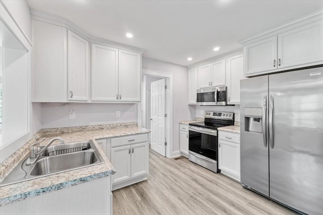 49 Je Sartain Rd, Manchester, TN 37355 - kitchen featuring stainless steel appliances, light wood finished floors, white cabinets, recessed lighting, and light countertops