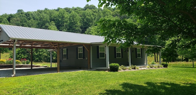 49 Je Sartain Rd, Manchester, TN 37355 - view of front of home featuring an attached carport, a front lawn, a metal roof, and driveway