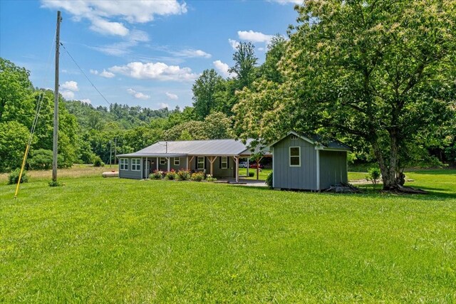 49 Je Sartain Rd, Manchester, TN 37355 - view of green lawn featuring a shed