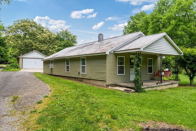49 Je Sartain Rd, Manchester, TN 37355 - view of property exterior with a yard, covered porch, a garage, a metal roof, and an outbuilding