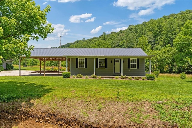 49 Je Sartain Rd, Manchester, TN 37355 - ranch-style home with a front yard, a metal roof, a porch, and a view of trees