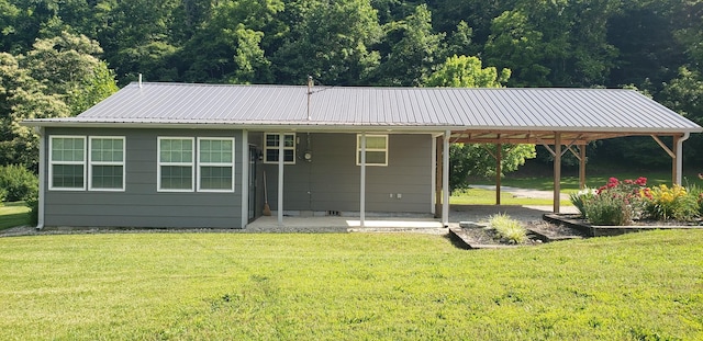 49 Je Sartain Rd, Manchester, TN 37355 - rear view of house featuring a yard, a carport, a metal roof, and a patio area