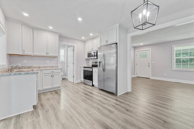 49 Je Sartain Rd, Manchester, TN 37355 - kitchen featuring appliances with stainless steel finishes, light countertops, plenty of natural light, white cabinetry, and recessed lighting
