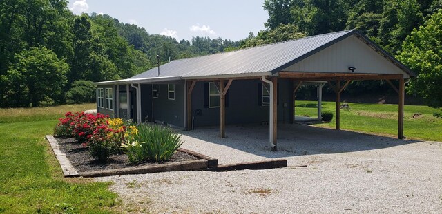 49 Je Sartain Rd, Manchester, TN 37355 - view of front of home with a front lawn, gravel driveway, a metal roof, and a forest view