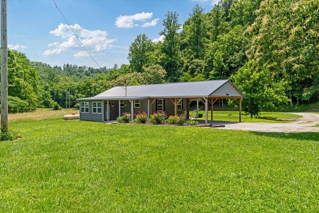 49 Je Sartain Rd, Manchester, TN 37355 - view of front of property featuring driveway, a front lawn, a metal roof, and a carport