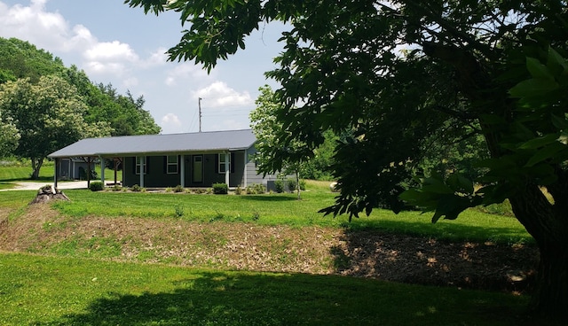 49 Je Sartain Rd, Manchester, TN 37355 - view of front of house with a front yard, a carport, and a metal roof
