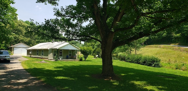 49 Je Sartain Rd, Manchester, TN 37355 - view of grassy yard with a porch, a detached garage, and an outdoor structure