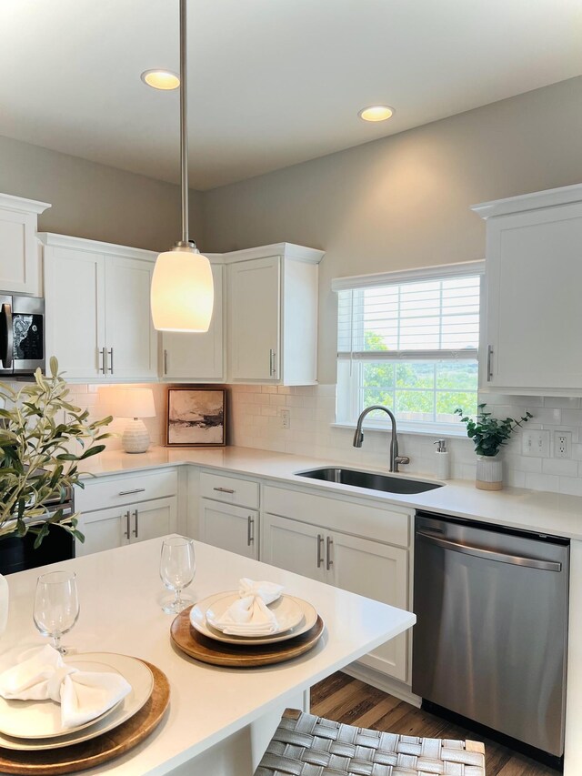 235 Dry Creek Commons, Goodlettsville, TN 37072 - kitchen with stainless steel appliances, light countertops, white cabinets, decorative backsplash, and recessed lighting