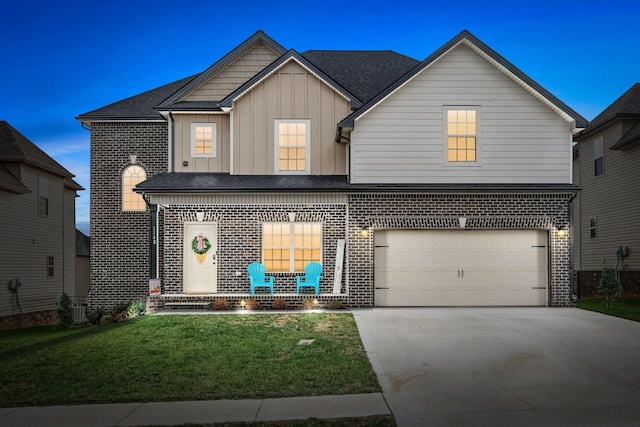 1148 Folly Beach Dr, Clarksville, TN 37042 - view of front facade with brick siding, driveway, a front lawn, board and batten siding, and a garage