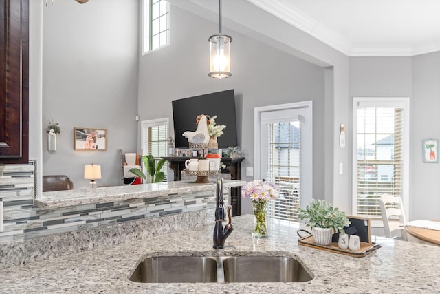 1148 Folly Beach Dr, Clarksville, TN 37042 - kitchen with light stone countertops, decorative light fixtures, and crown molding