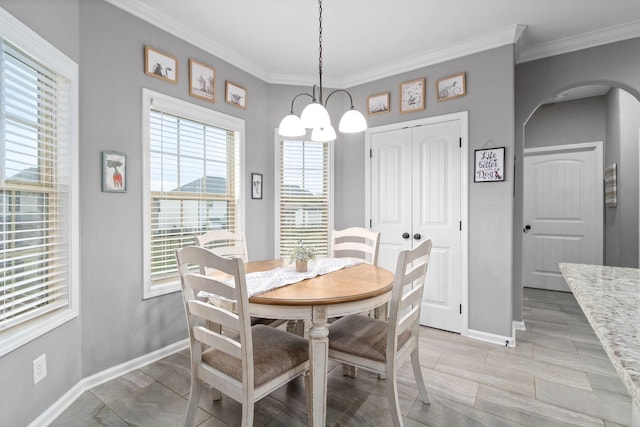 1148 Folly Beach Dr, Clarksville, TN 37042 - dining space with a chandelier, arched walkways, plenty of natural light, ornamental molding, and wood tiled floors
