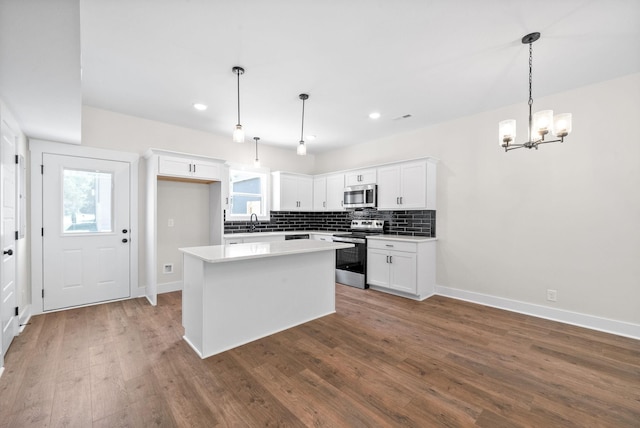 198 Cave St Unit C, Clarksville, TN 37042 - kitchen with appliances with stainless steel finishes, a chandelier, a center island, wood finished floors, and recessed lighting