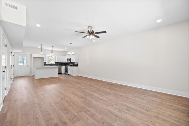 198 Cave St Unit C, Clarksville, TN 37042 - unfurnished living room featuring recessed lighting, a chandelier, light wood-style floors, and a ceiling fan