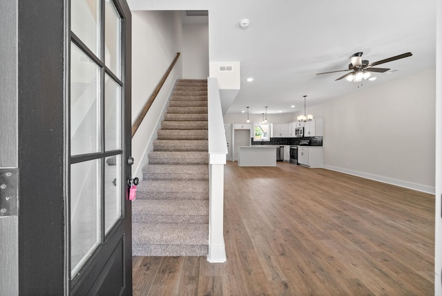 198 Cave St Unit C, Clarksville, TN 37042 - staircase with ceiling fan, wood finished floors, a chandelier, and recessed lighting