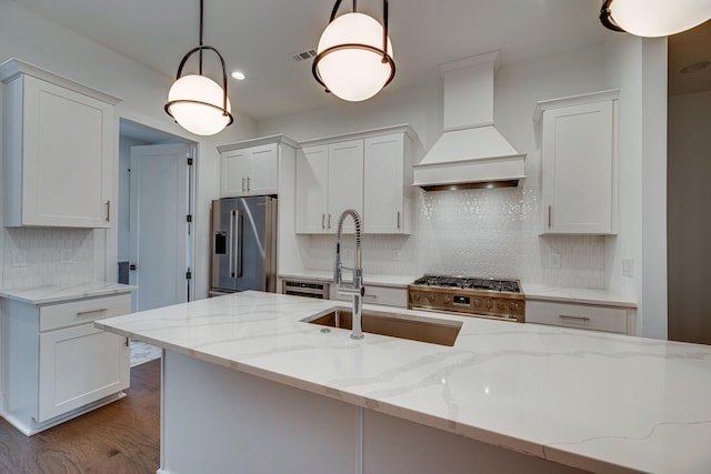 117 Shadow Springs Dr Unit 117, Brentwood, TN 37027 - kitchen with high end appliances, premium range hood, decorative backsplash, white cabinets, and recessed lighting
