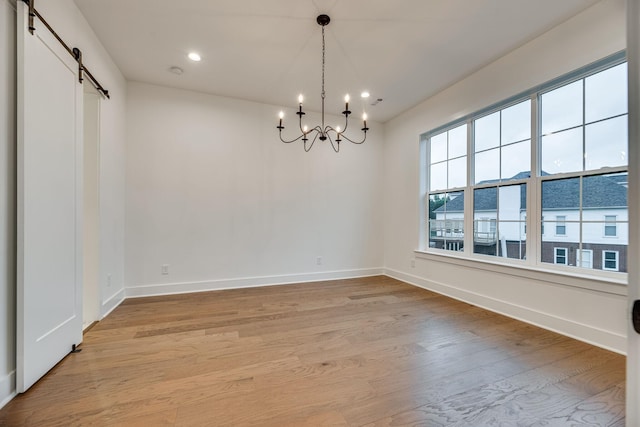 117 Shadow Springs Dr Unit 117, Brentwood, TN 37027 - spare room with a barn door, a chandelier, light wood-style flooring, and recessed lighting