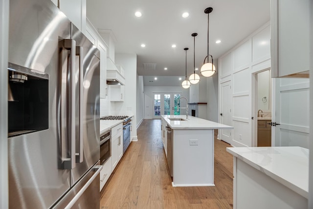 117 Shadow Springs Dr Unit 117, Brentwood, TN 37027 - kitchen featuring stainless steel appliances, white cabinetry, a center island with sink, light wood-style flooring, and recessed lighting