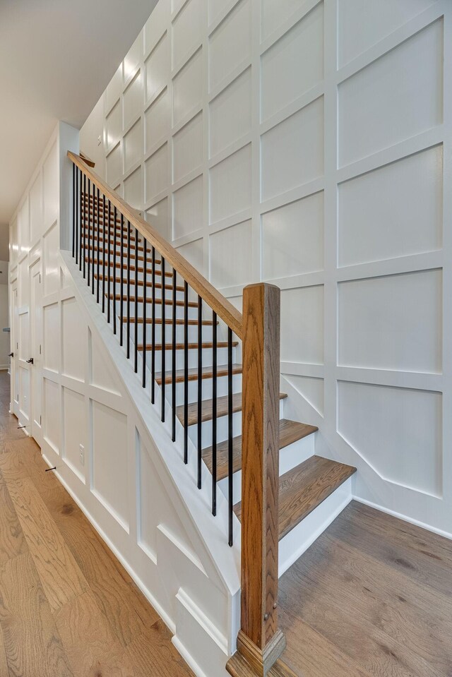 117 Shadow Springs Dr Unit 117, Brentwood, TN 37027 - staircase featuring a decorative wall and wood finished floors