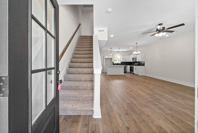 198 Cave St Unit A, Clarksville, TN 37042 - stairway with ceiling fan, wood finished floors, a chandelier, and recessed lighting