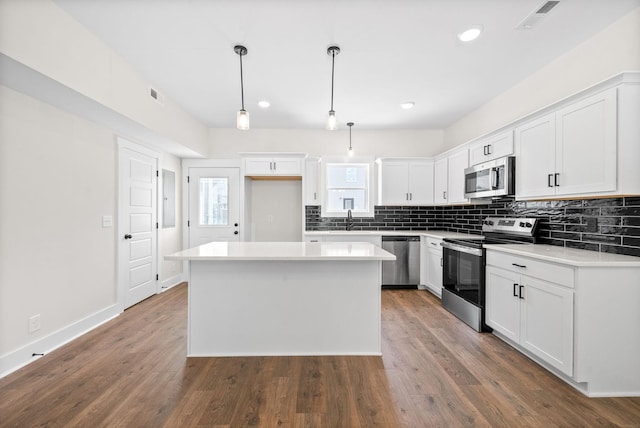 198 Cave St Unit A, Clarksville, TN 37042 - kitchen with stainless steel appliances, a center island, tasteful backsplash, white cabinetry, and recessed lighting